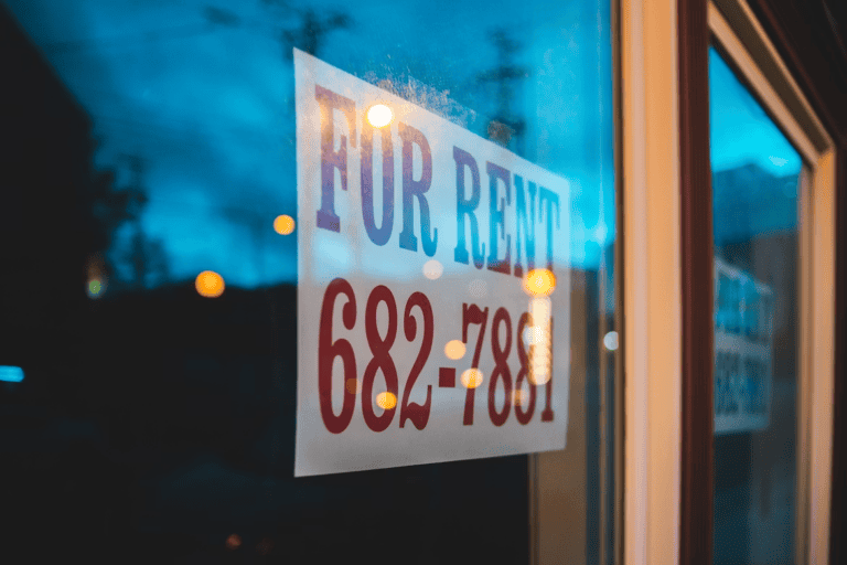 Landlord reviewing a lease and the Alberta Residential Tenancies Act rules for a rental property