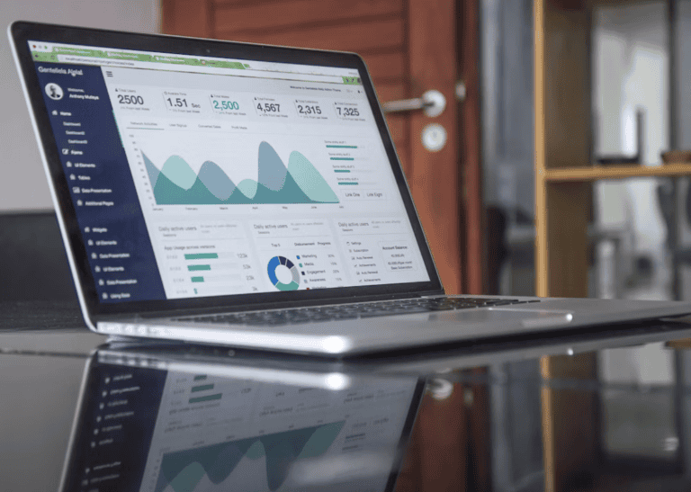 Realtor comparing the best real estate websites on a laptop and phone to plan a better site