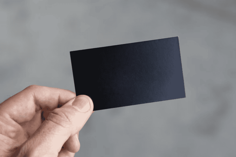 Real estate agent handing a business card to a client at an Edmonton open house