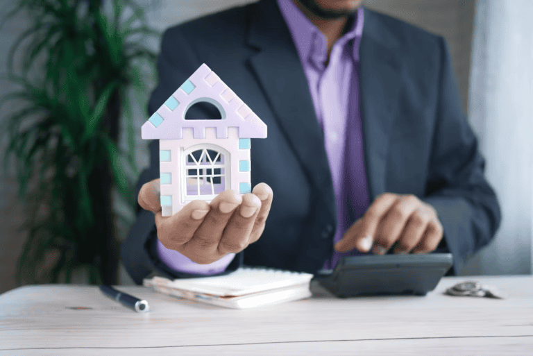 Homeowner reviewing an insurance policy and repair estimate at a kitchen table before selling