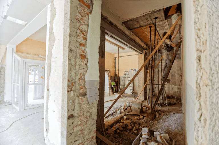 Homeowner inspecting a finished Edmonton basement before repairing water damage to sell