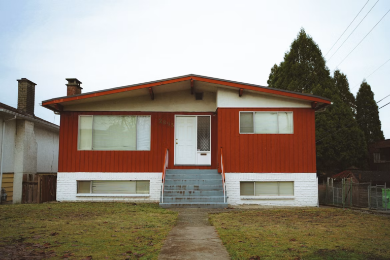 Edmonton rental duplex with a for sale sign, representing selling a rental property in Edmonton