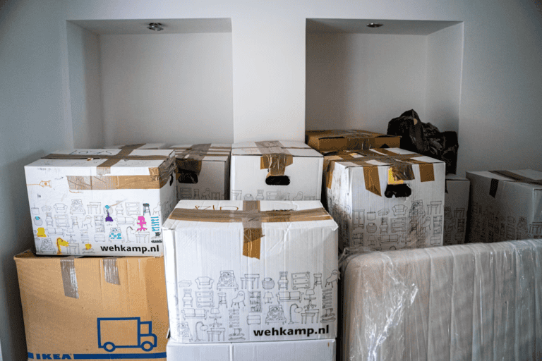 Moving boxes and a laptop in an Edmonton home, representing selling a home for a job relocation