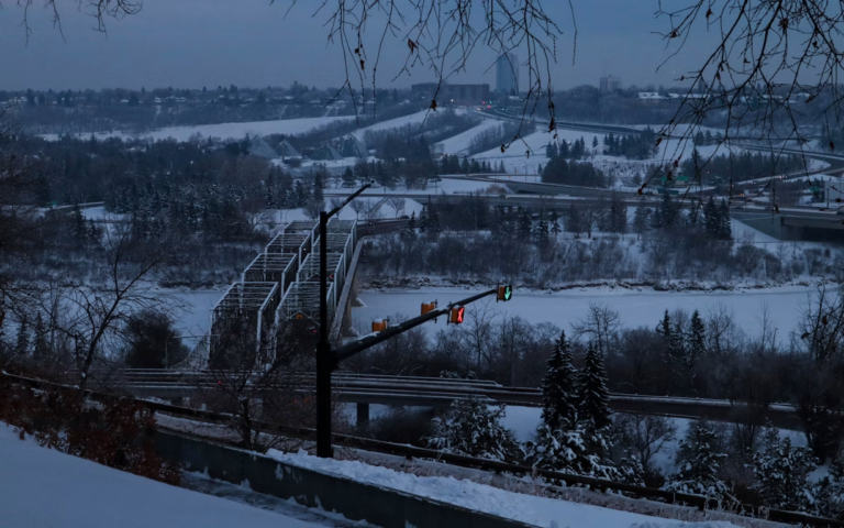 Cozy, well-lit Edmonton home with cleared snowy walkway, prepared for selling a house in winter