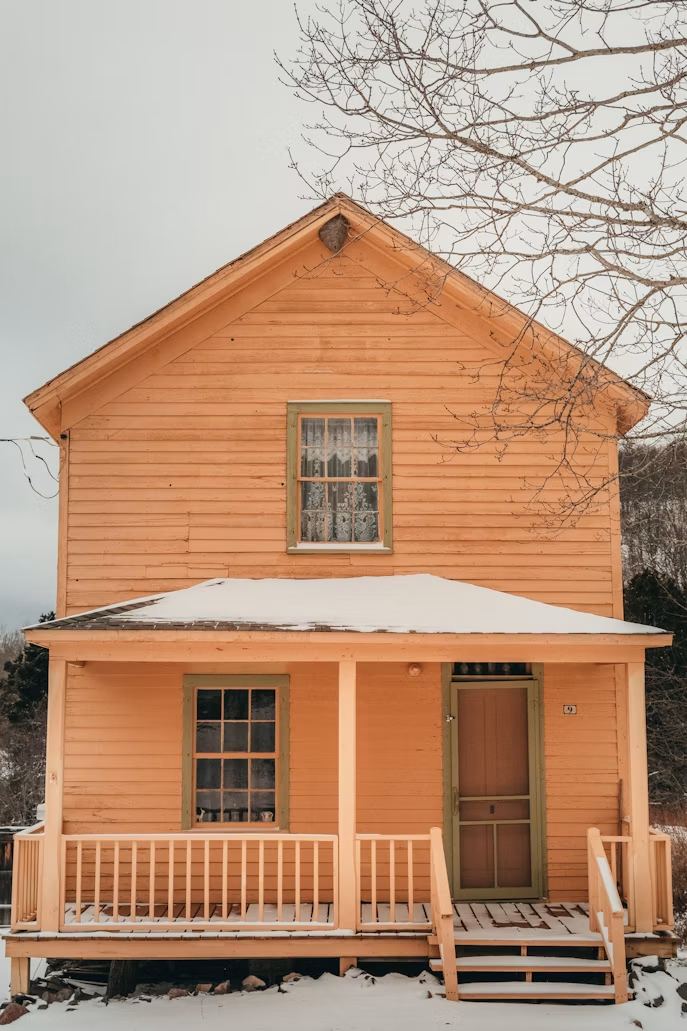 Home with a worn roof and dated exterior in Alberta, representing selling a home that needs repairs