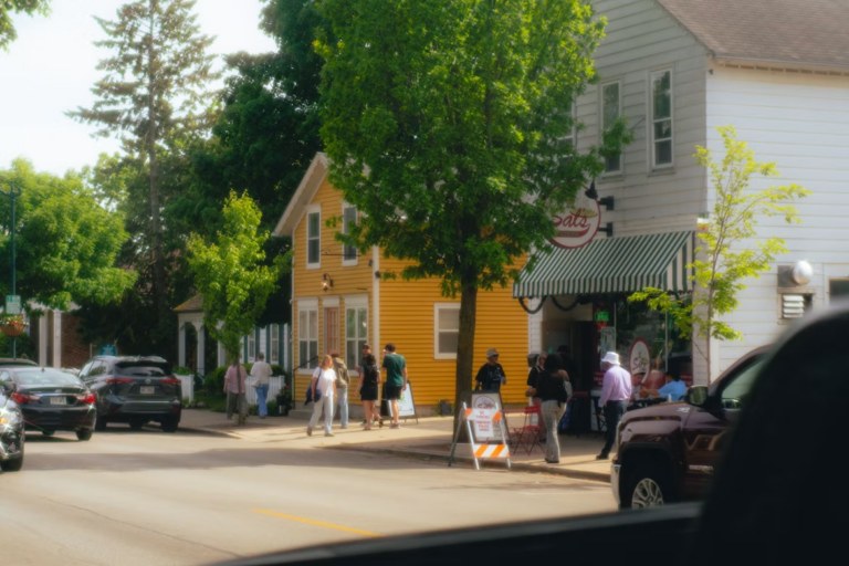 People walking a shop-lined street in one of the most walkable communities in Edmonton