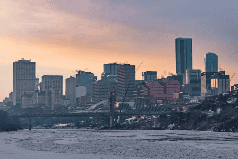 Edmonton river valley in winter with snow-covered trees and the downtown skyline, showing Edmonton climate weather