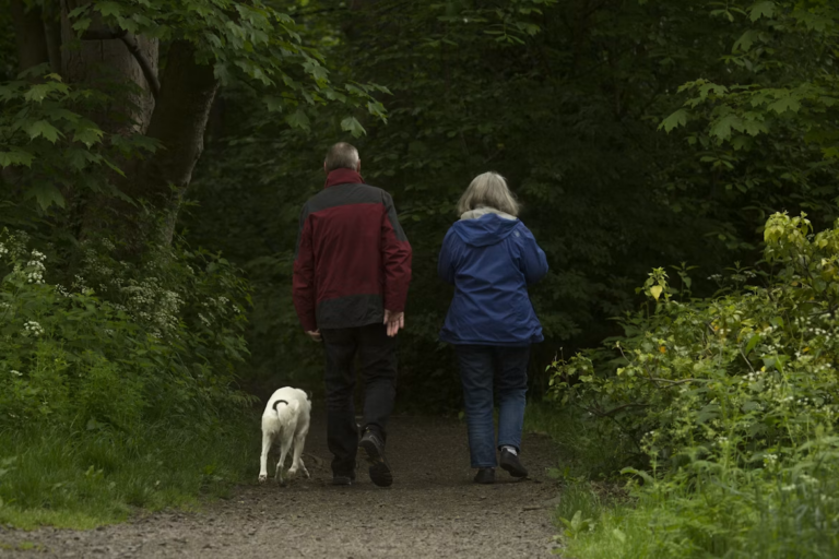 Retired couple walking a quiet tree-lined street in one of the best communities in Edmonton for retirees
