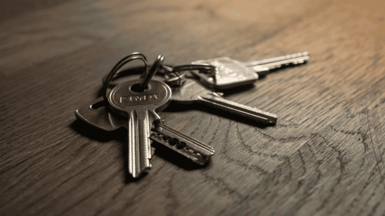 Legal documents and a house key on a desk, representing probate and selling a home in Alberta