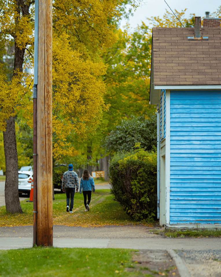 People walking past cafes on Whyte Avenue in one of the most walkable Edmonton neighbourhoods