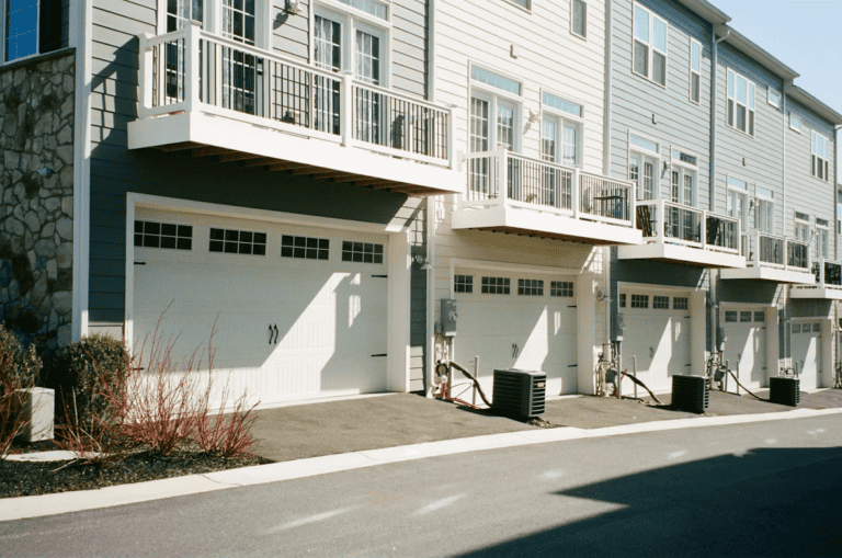 Row of townhouses beside a low-rise condo building, illustrating townhouse vs condo Edmonton