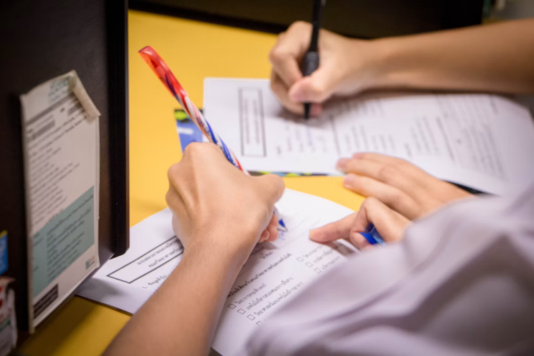 Buyer and seller signing documents for a seller financing Alberta property deal