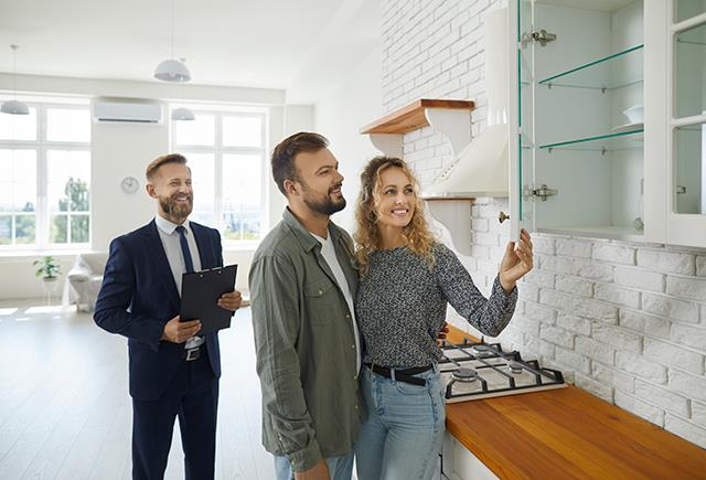Home buyers comparing notes outside a house during a showing in Edmonton